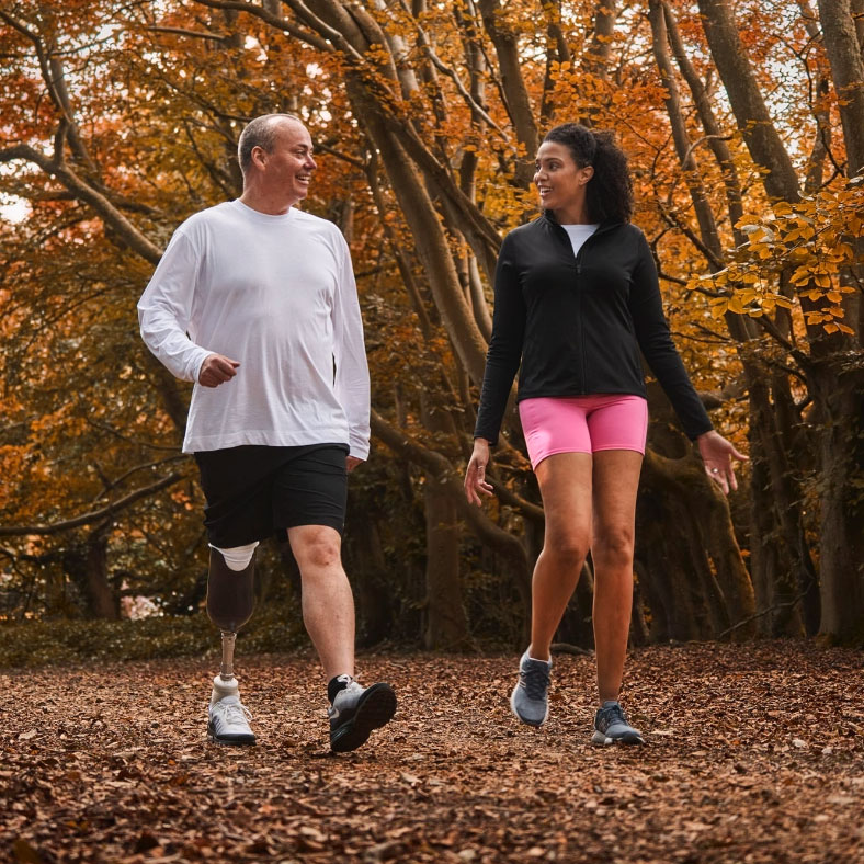 Two people exercise in the woods